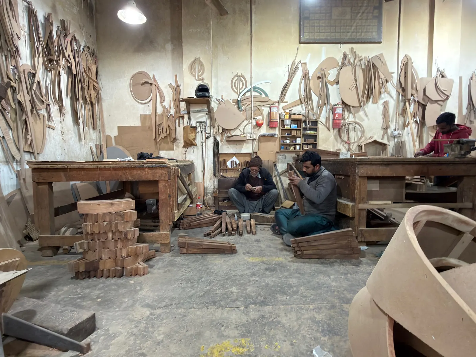 Wide view of the workshop floor with the team hand-carving pieces