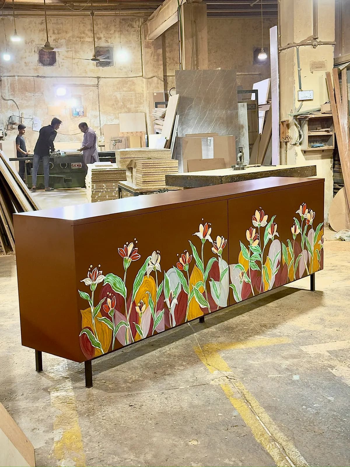 A hand-painted floral sideboard finished on the workshop floor
